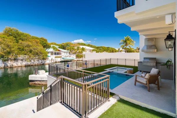 a view of swimming pool with outdoor seating and plants