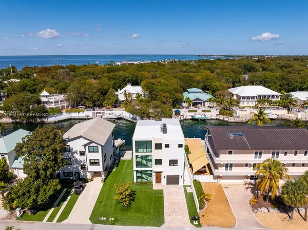 an aerial view of residential building and ocean