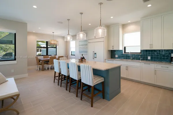 a large kitchen with a table and chairs