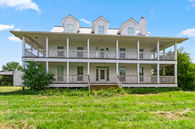 front view of two large windows and a yard