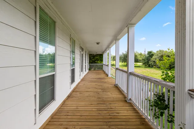 a view of a balcony with wooden floor