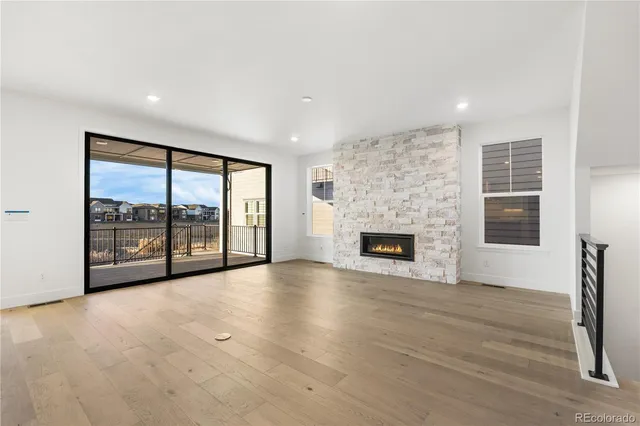 a view of an empty room with a fireplace and a window