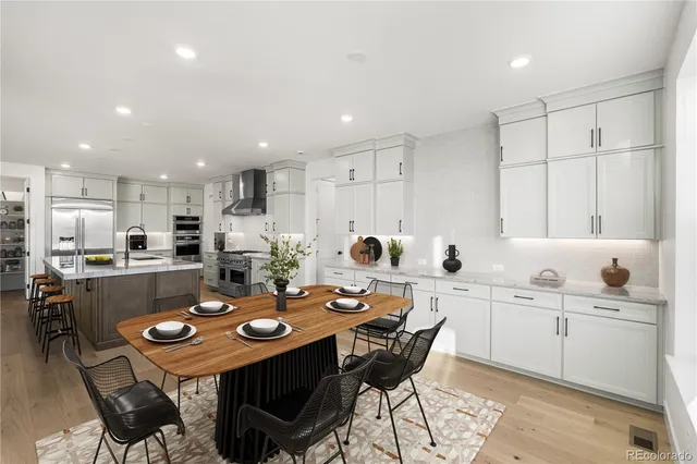 a large kitchen with a table and chairs