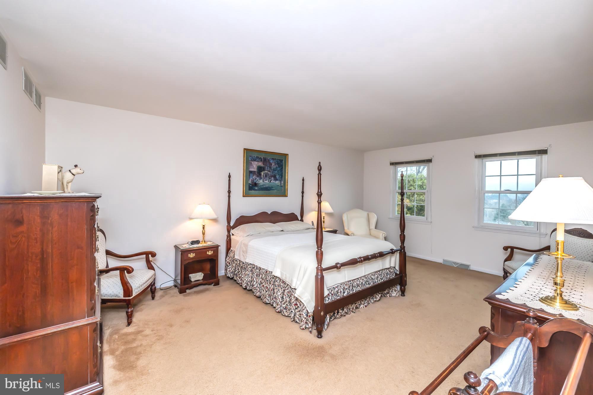 30 Estates Drive Reading, PA 19606 - Photo 25 of 45 a spacious bedroom with a bed and a lamp on table