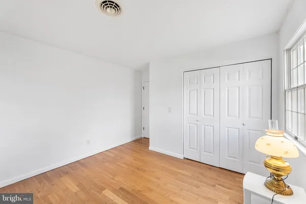 a view of a room with wooden floor and window