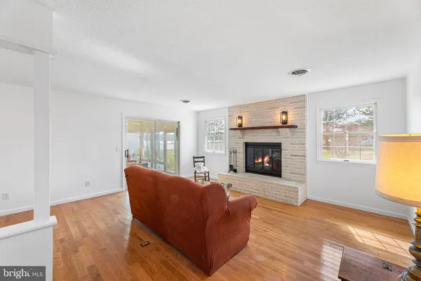 a living room with furniture a window and a fireplace