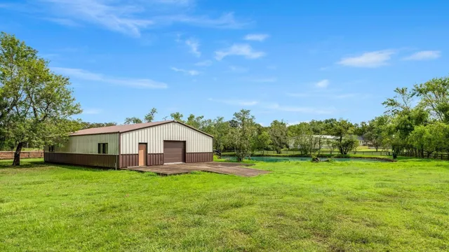 a view of a house with a yard and sitting area