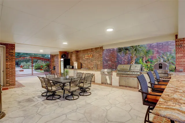 a view of a dining room with furniture and a floor to ceiling window