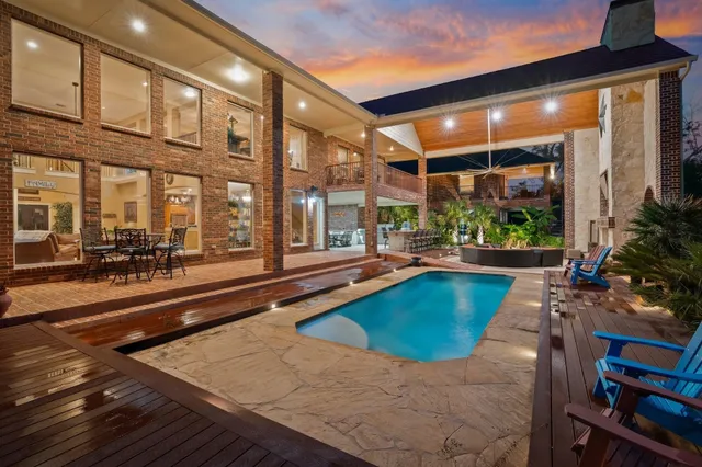 a view of a swimming pool with outdoor seating