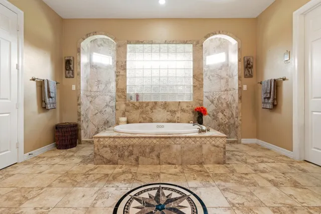 a bathroom with a tub sink and shower