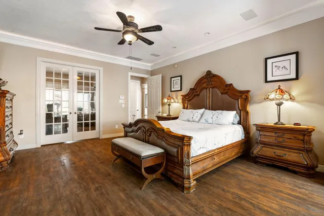 a bedroom with a bed and wooden floor
