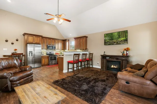 a living room with furniture kitchen view and a fireplace
