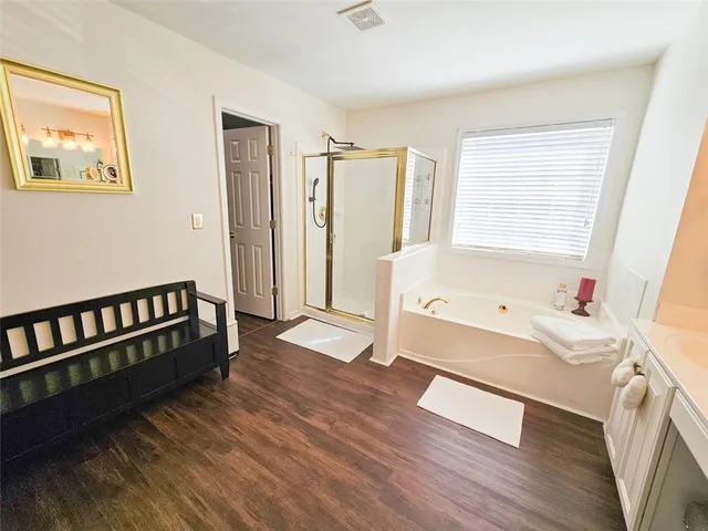 a bathroom with a bathtub a sink and a window