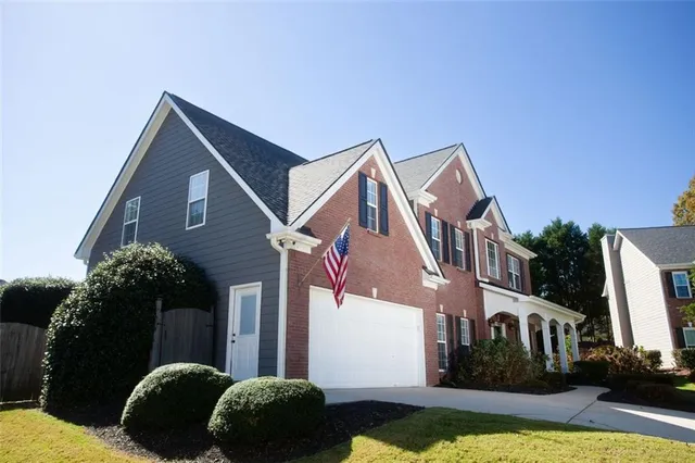 a front view of a house with a yard