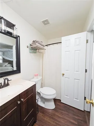 a bathroom with a sink a toilet a shower and a mirror