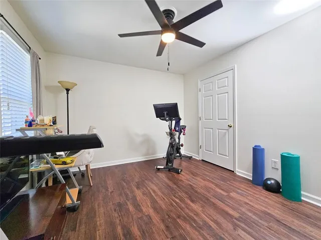 a view of a workspace with furniture and wooden floor