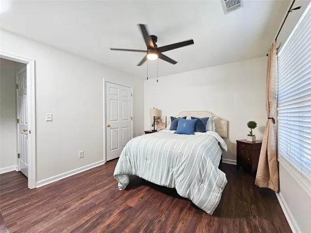 a bedroom with a bed and wooden floor