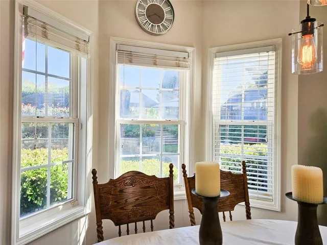 a room with musical instrument pool table chairs and windows