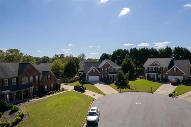 an aerial view of a house with a yard