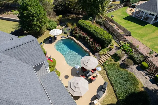 an aerial view of house with yard swimming pool and outdoor seating