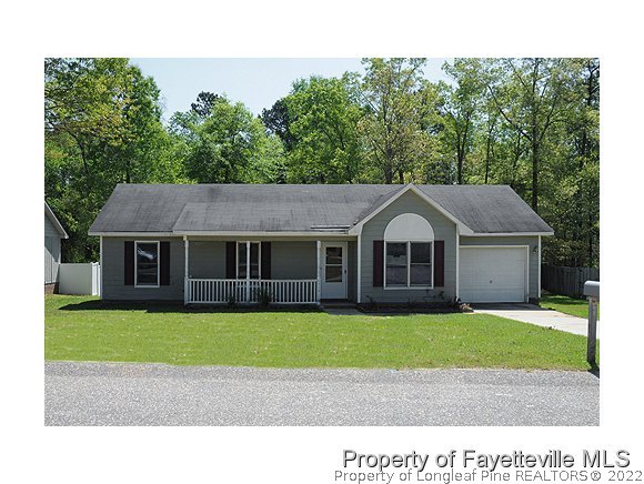 6475 Applewhite Road Fayetteville, NC 28304 - Photo 1 of 6 a house that has a big yard with plants and large trees