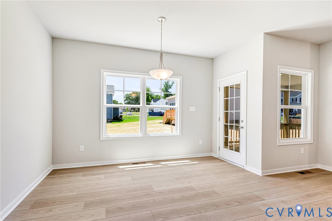 10010 Cool Spring Road Mechanicsville, VA 23116 - Photo 7 of 13 Light wood-finish flooring, white walls, large win