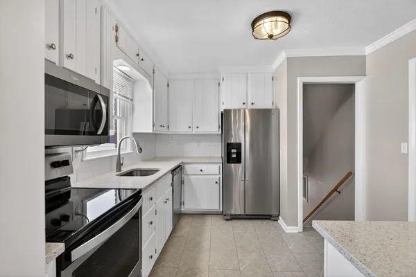 a view of a kitchen from the hallway