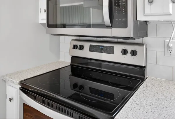 a view of a kitchen with wooden floor and electronic appliances