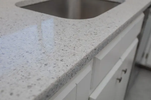 a large kitchen with stainless steel appliances granite countertop a stove a sink dishwasher and a refrigerator with wooden floor