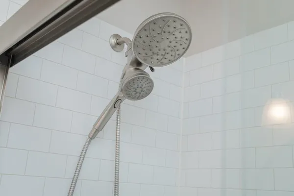 an empty room with wooden floor fireplace and windows