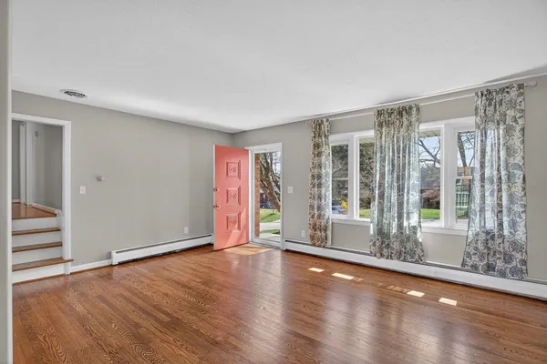 wooden floor fireplace and natural light in room