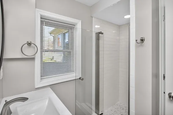 a view of an empty room with furniture and a flat screen tv