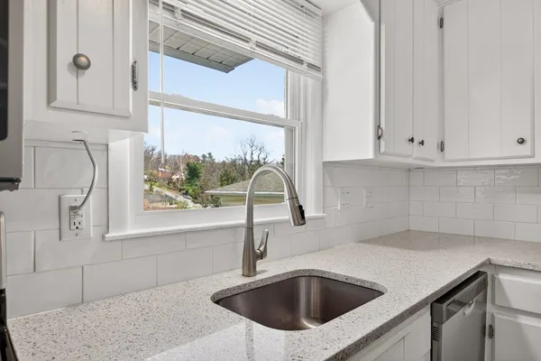 a stove top oven sitting inside of a kitchen