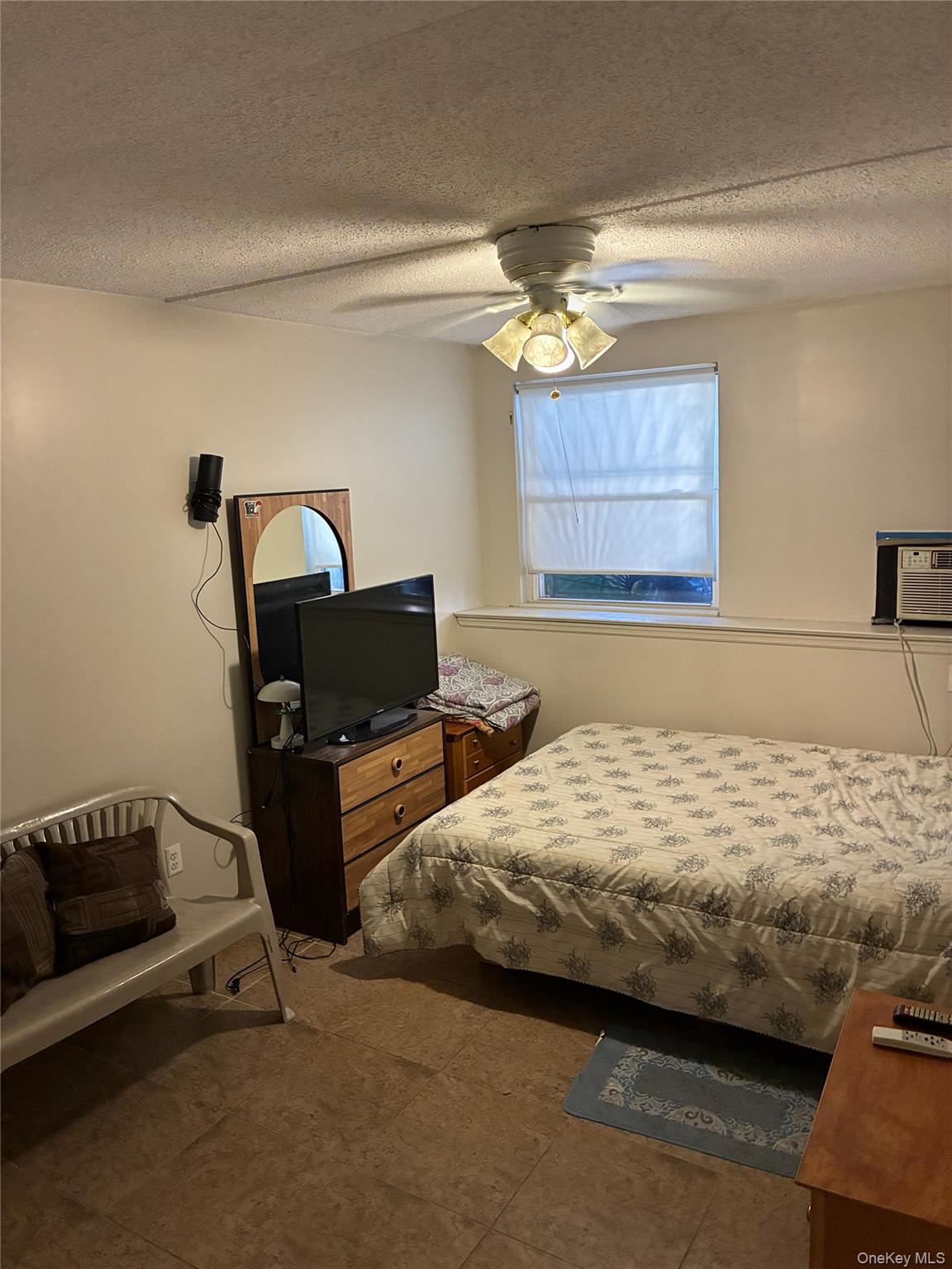 21 Renaissance Court Brooklyn, NY 11206 - Photo 14 of 21 a bedroom with bed and window