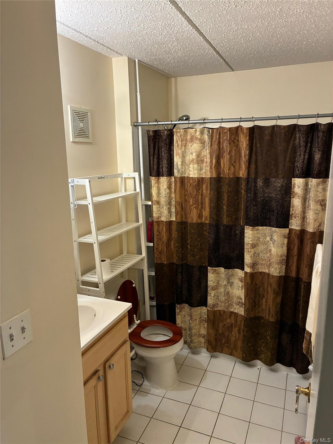 21 Renaissance Court Brooklyn, NY 11206 - Photo 15 of 21 a bathroom with a sink toilet and shower
