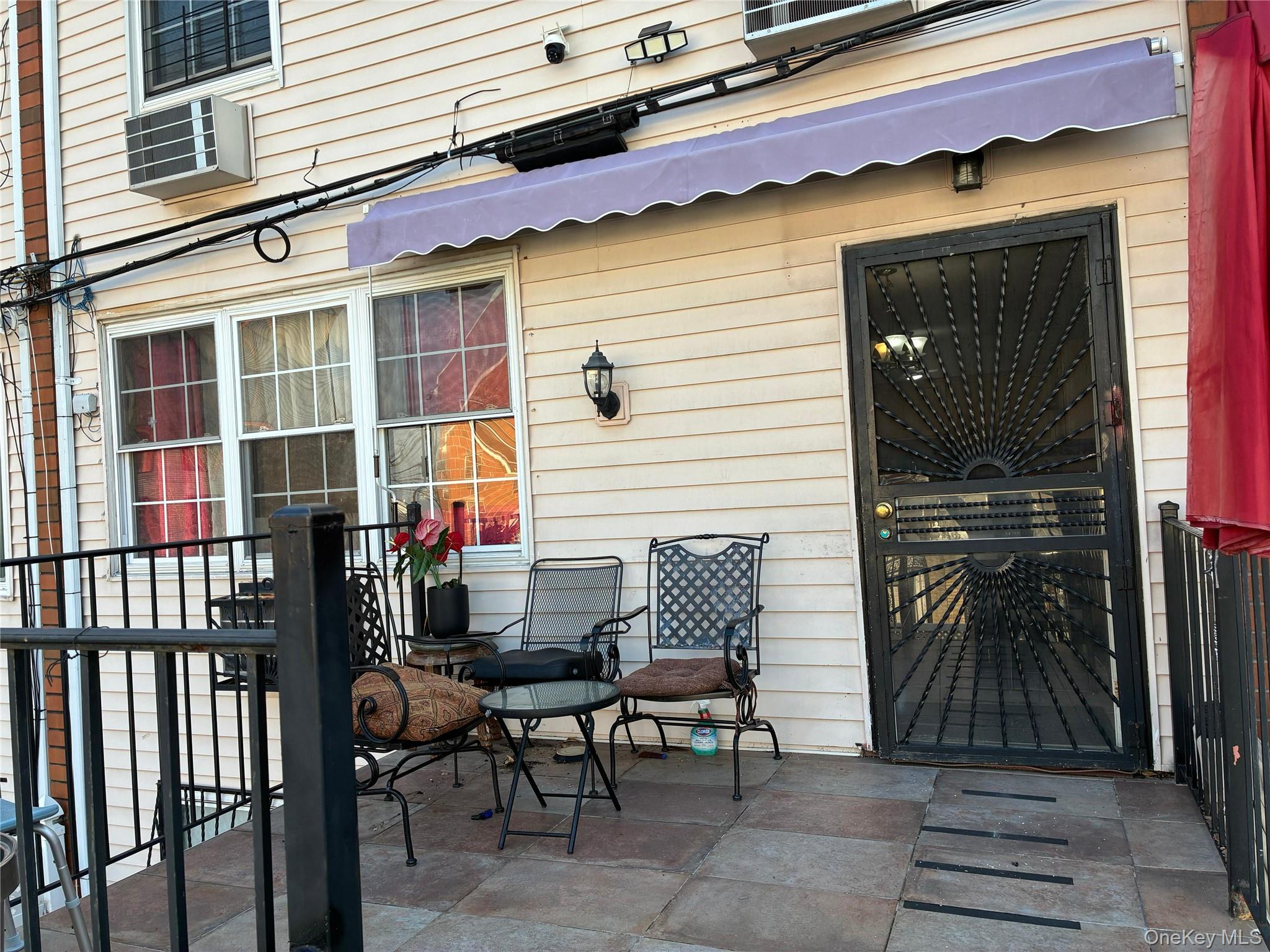 21 Renaissance Court Brooklyn, NY 11206 - Photo 16 of 21 a backyard of a house with barbeque oven table and chairs