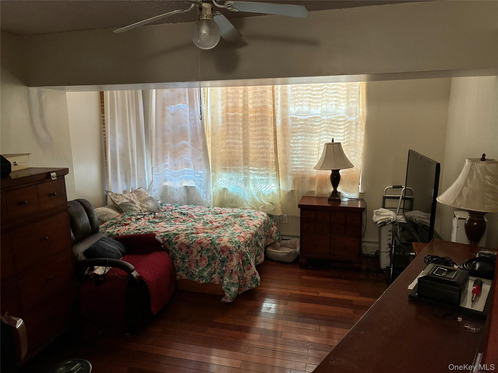 21 Renaissance Court Brooklyn, NY 11206 - Photo 6 of 21 a bedroom with a bed and a large window