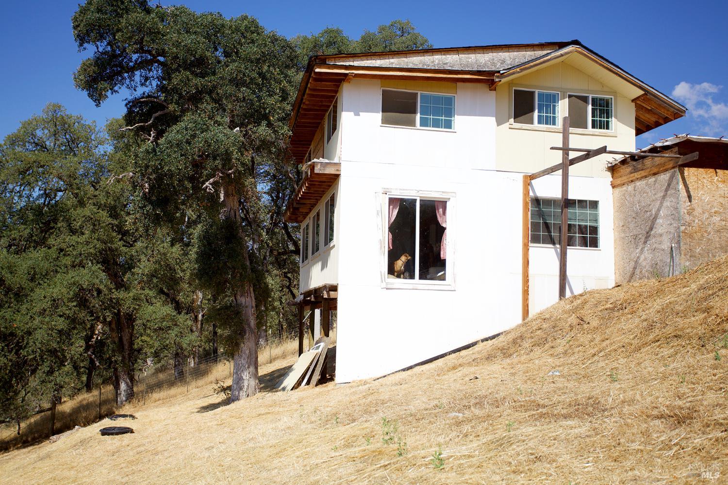 35100 Mendocino Pass Road Covelo, CA 95428 - Photo 3 of 14 a view of a white house with a large tree