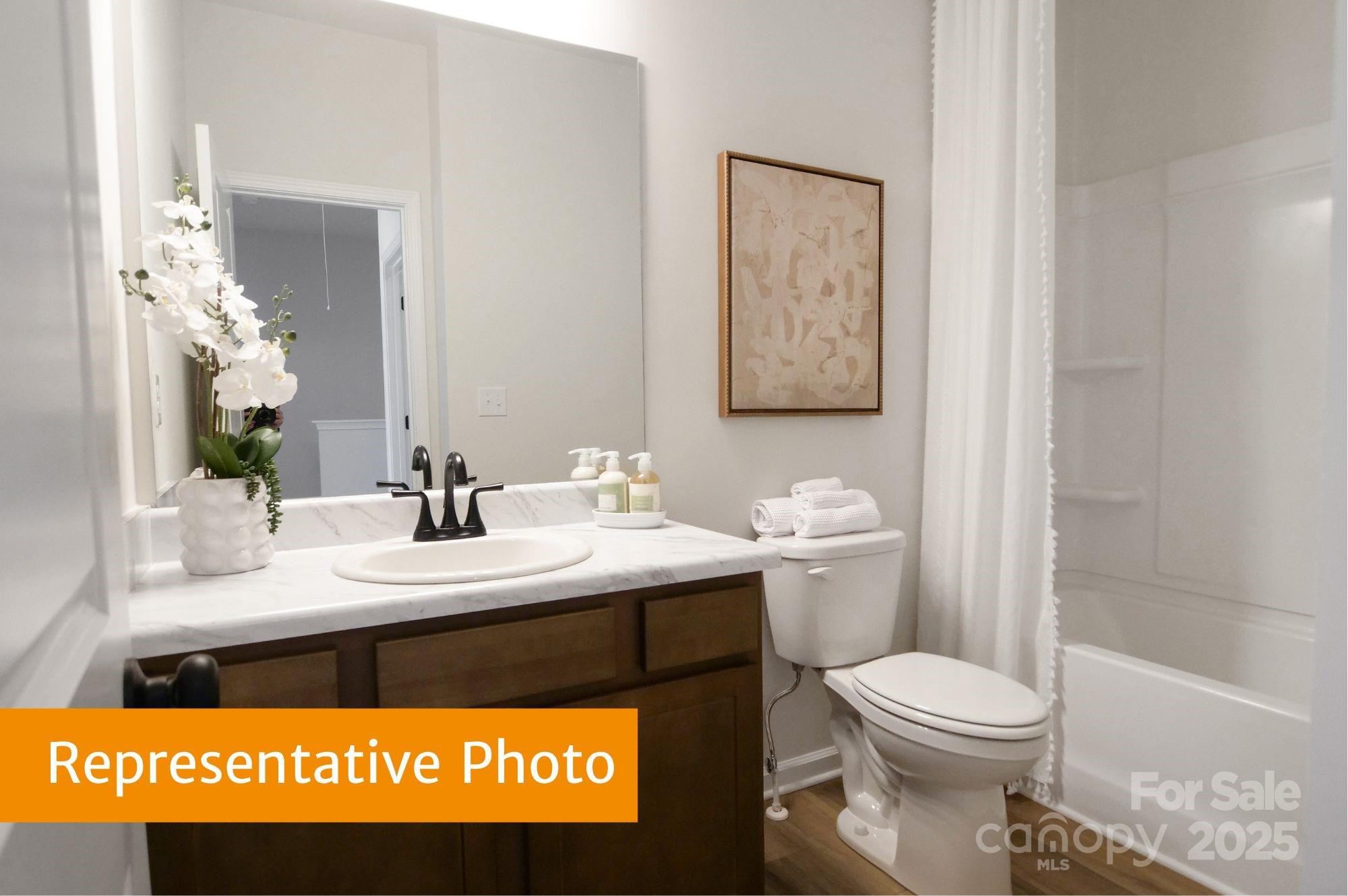 5612 Ringneck Road Charlotte, NC 28216 - Photo 19 of 24 a bathroom with a granite countertop toilet sink and mirror