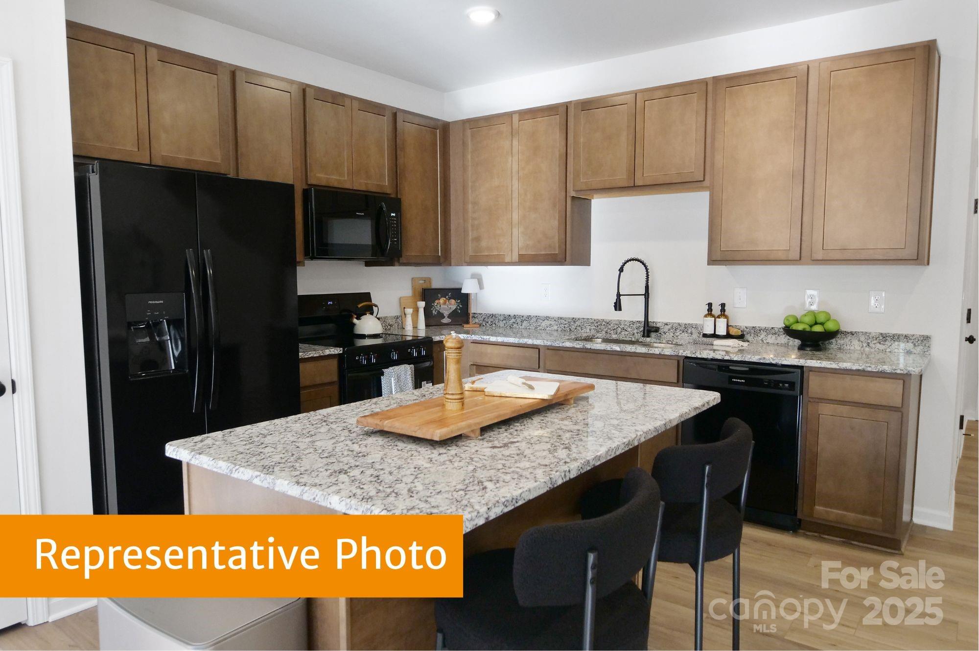5612 Ringneck Road Charlotte, NC 28216 - Photo 3 of 24 a kitchen with granite countertop a sink a stove and refrigerator