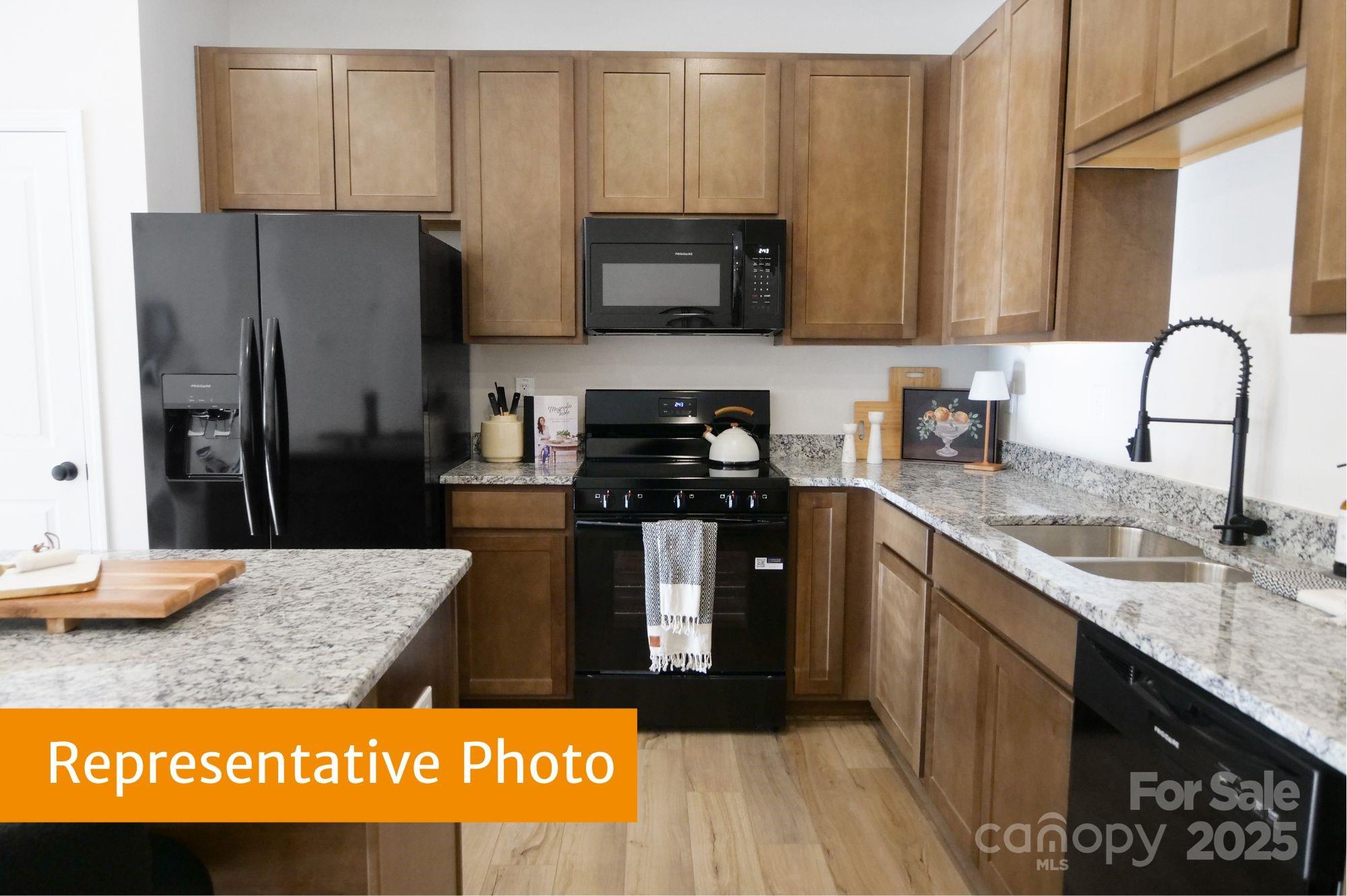 5612 Ringneck Road Charlotte, NC 28216 - Photo 4 of 24 a kitchen with stainless steel appliances granite countertop a refrigerator and a stove