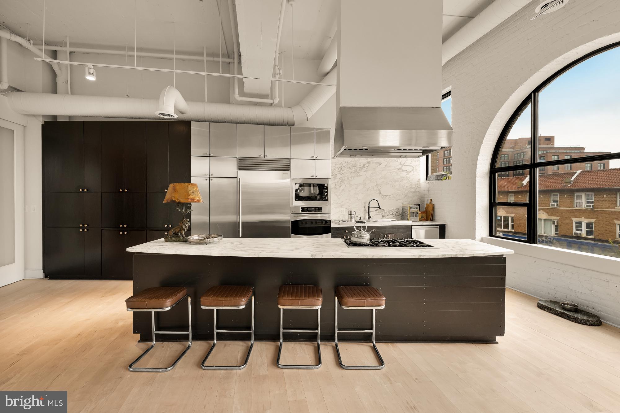 2424 18th Street Northwest, Unit R1 Washington, DC 20009 - Photo 12 of 24 a kitchen with a table chairs sink and cabinets