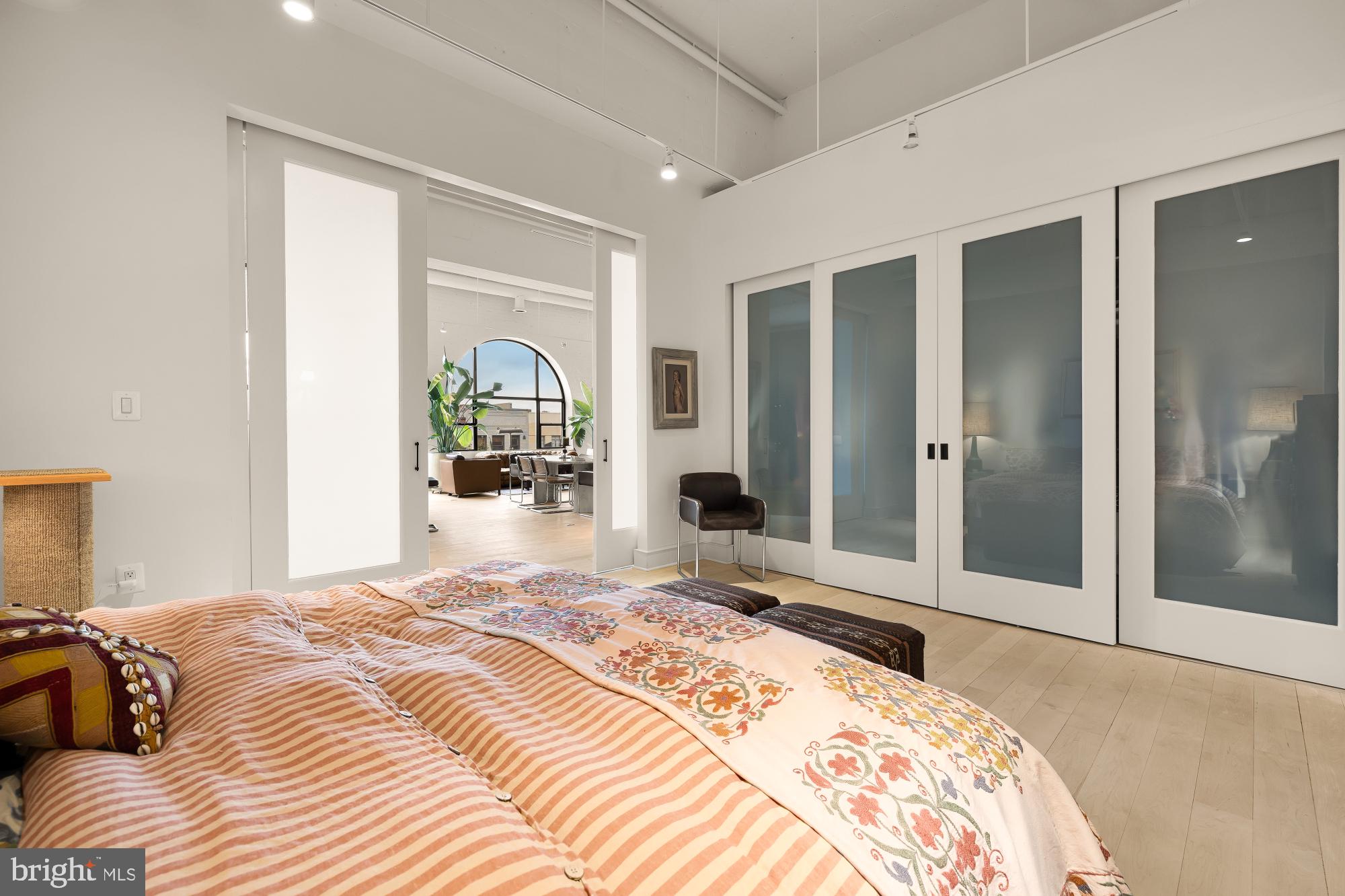 2424 18th Street Northwest, Unit R1 Washington, DC 20009 - Photo 18 of 24 a bedroom with a large bed and a chandelier