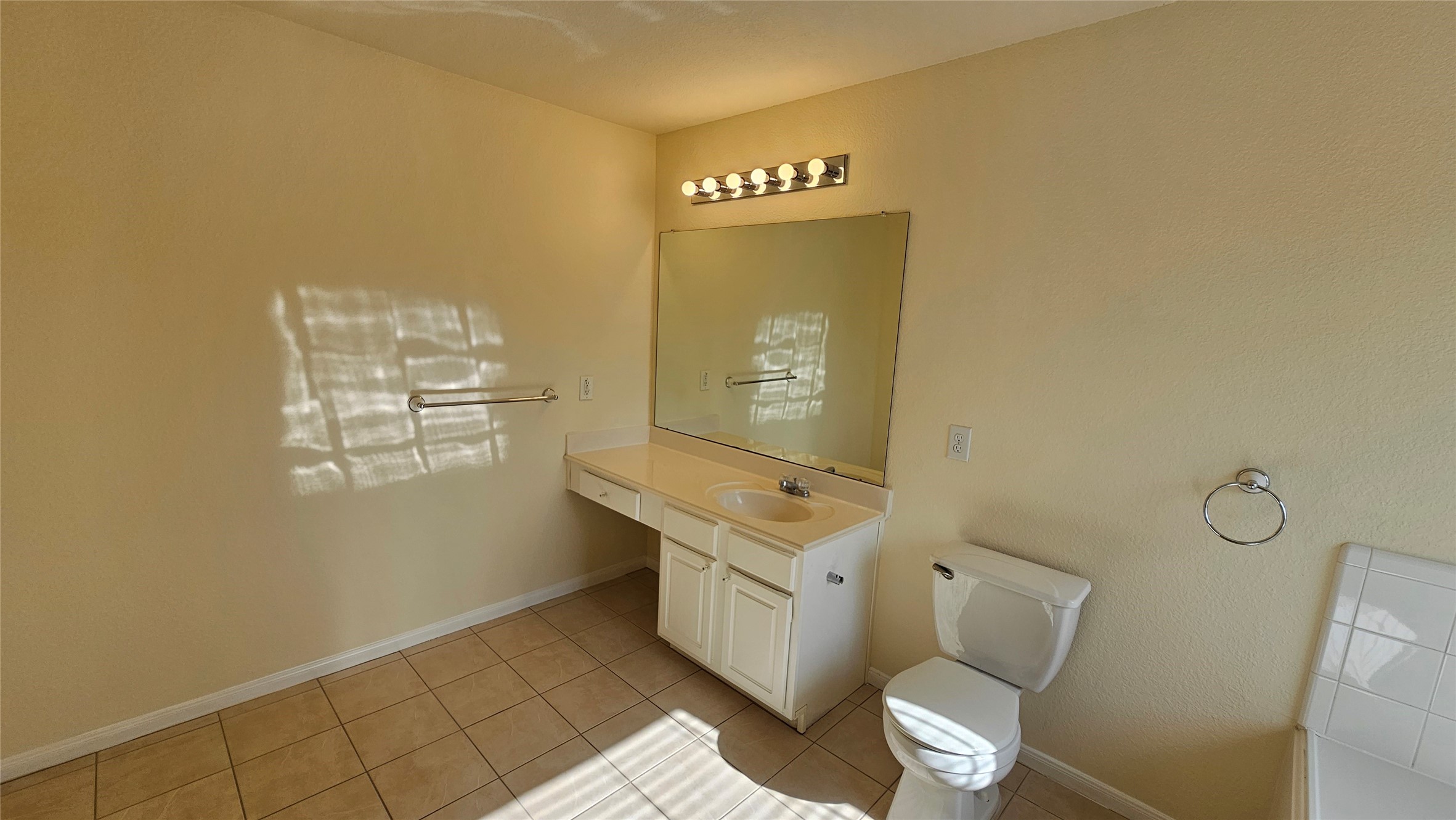 7918 Barnes Ridge Lane Houston, TX 77072 - Photo 26 of 34 This bathroom features neutral tones with a single vanity, a large mirror, and overhead lighting.