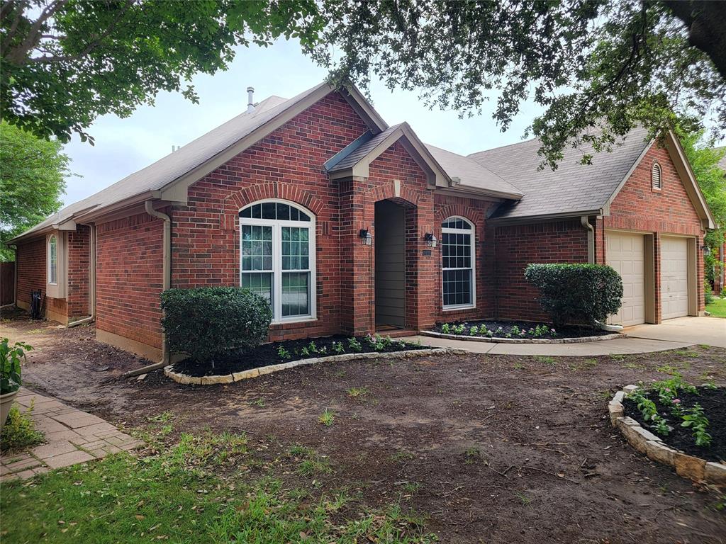 1604 Knoll Ridge Circle Corinth, TX 76210 - Photo 3 of 37 Brick exterior with an arched entry, two-car garage, multiple gabled rooflines, and a paved driveway