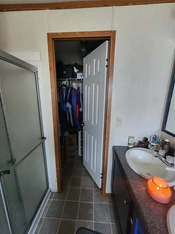 a bathroom with a sink a toilet and a shower