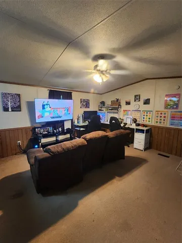 a living room with furniture and a kitchen view