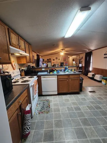 a kitchen with a sink a counter top space cabinets and appliances