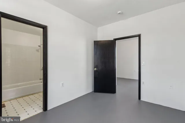 a bathroom with a bathtub sink vanity and mirror