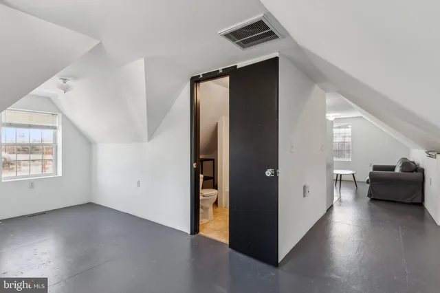 an empty room with windows and closet